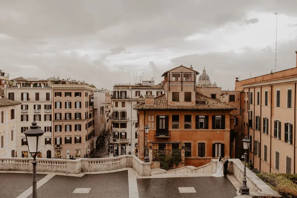 Rome Elopement for Shy Couples: Enjoy Privacy in a Busy City 1 Rome skyline and Spanish Steps with shy couple in foreground