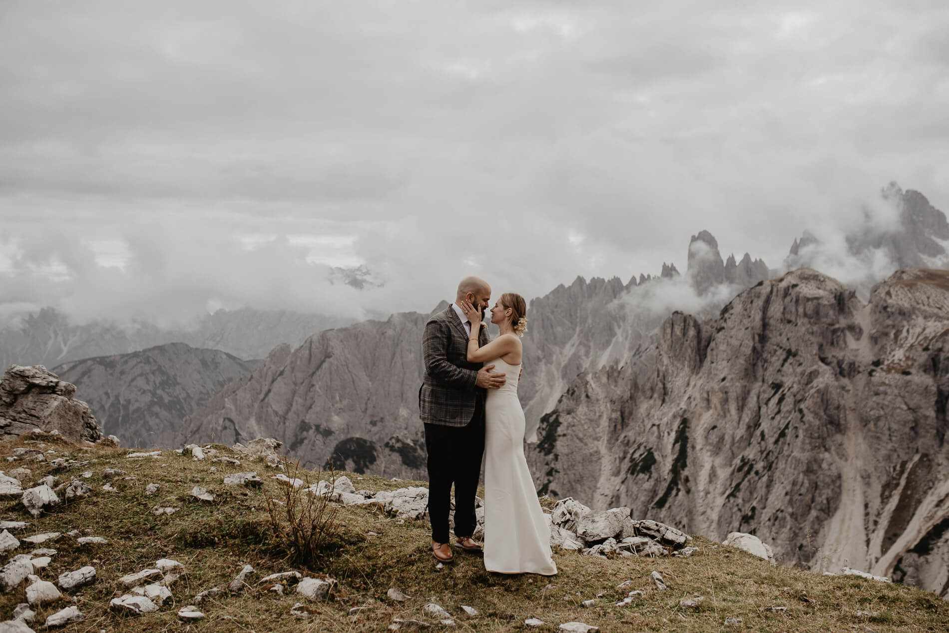 Couple exchanging vows in the Dolomites surrounded by mountains